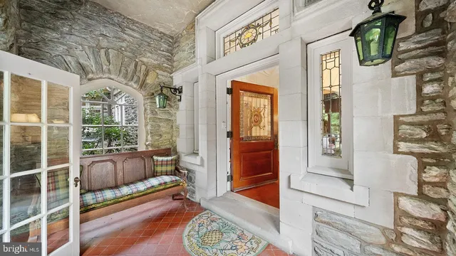 a view of an empty room with a fireplace and a window