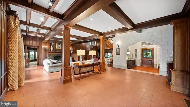 a dining room with furniture a chandelier and window