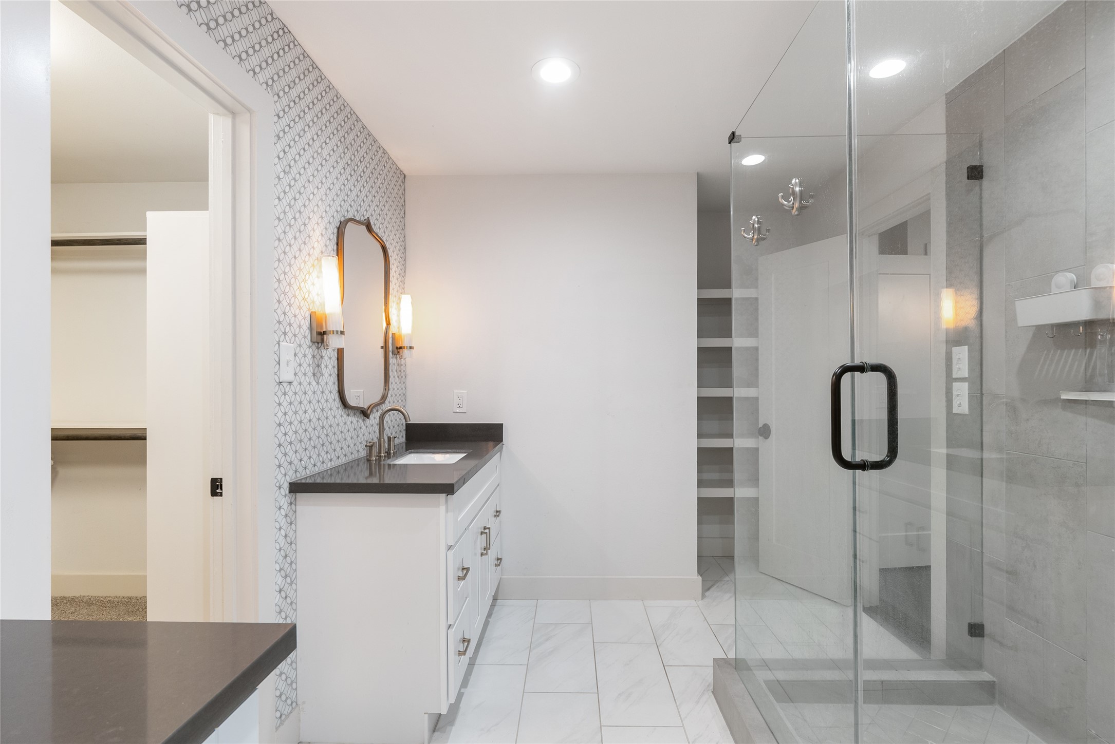 7307 Raton Street Houston, TX 77055 - Photo 15 of 23 The primary bathroom is elegant with marble look tile and frameless glass shower enclosure