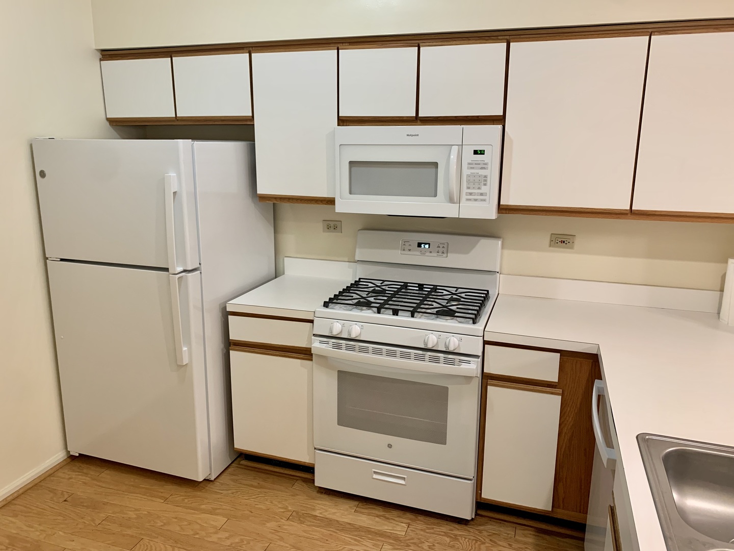17870 Braewick Road Gurnee, IL 60031 - Photo 11 of 28 a white refrigerator freezer and a stove sitting inside of a kitchen
