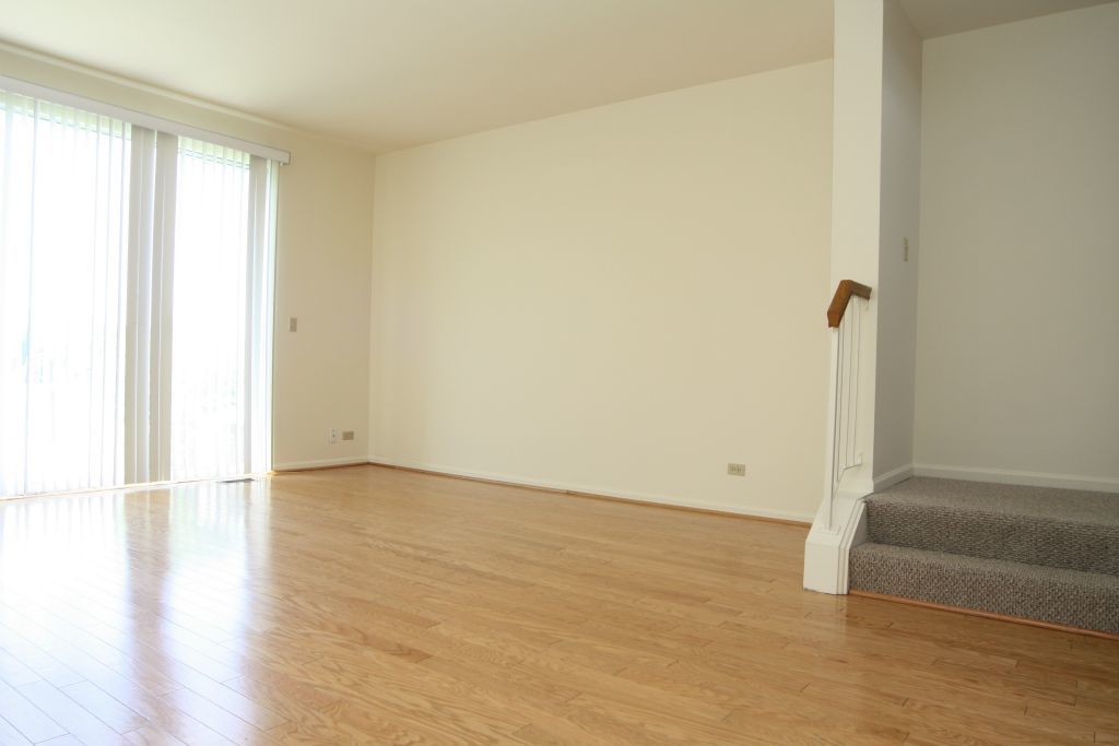 17870 Braewick Road Gurnee, IL 60031 - Photo 6 of 28 an empty room with wooden floor and windows