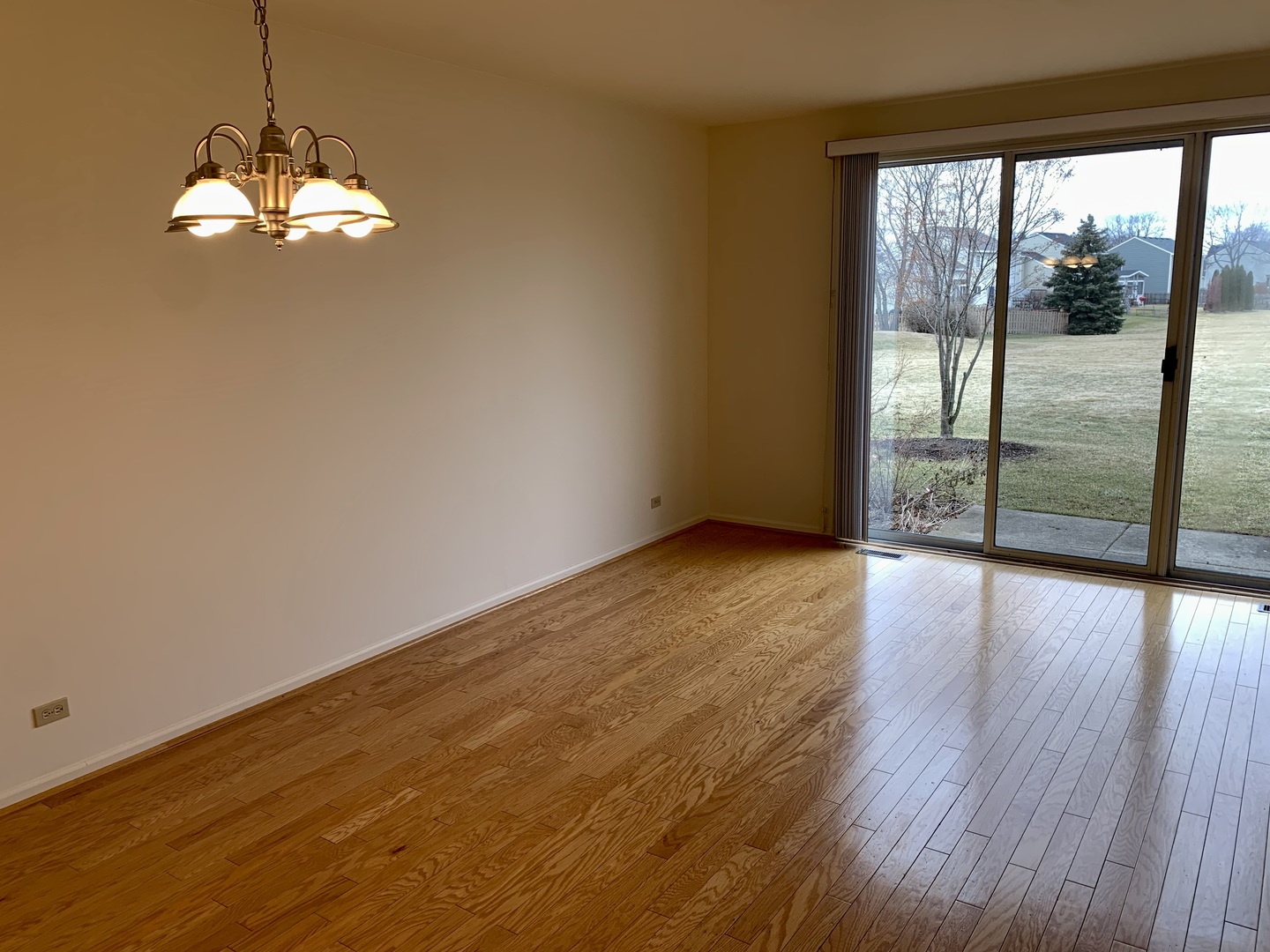 17870 Braewick Road Gurnee, IL 60031 - Photo 7 of 28 an empty room with wooden floor and windows