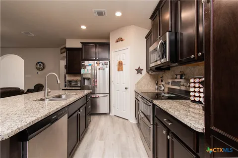 a view of a hallway with closet and a bathroom view