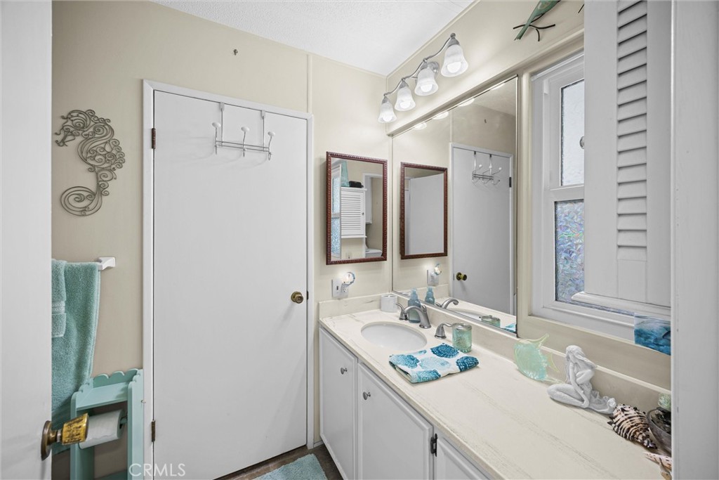 9800 Base Line Road, Unit 71 Rancho Cucamonga, CA 91701 - Photo 14 of 42 a bathroom with a granite countertop sink mirror and a shower