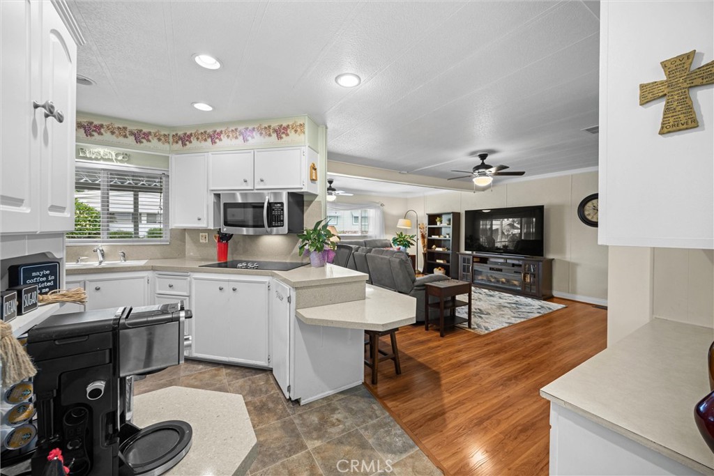 9800 Base Line Road, Unit 71 Rancho Cucamonga, CA 91701 - Photo 16 of 42 a kitchen with sink refrigerator and cabinets