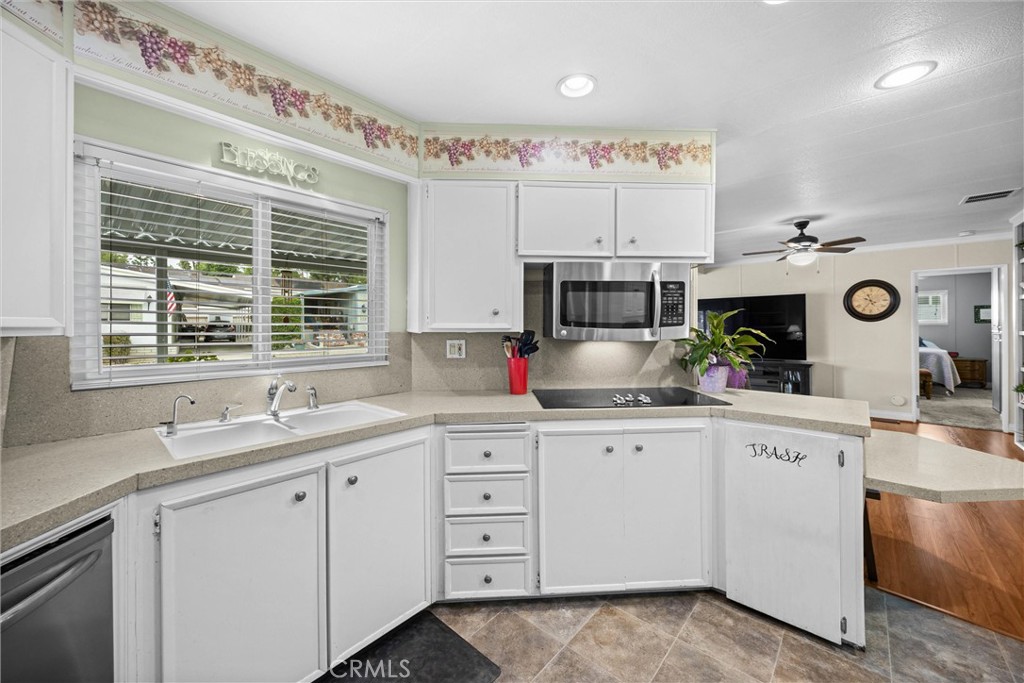 9800 Base Line Road, Unit 71 Rancho Cucamonga, CA 91701 - Photo 19 of 42 a kitchen with cabinets appliances a sink and a window