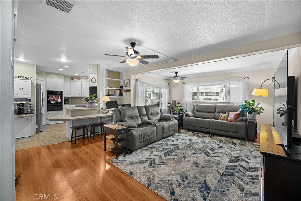 9800 Base Line Road, Unit 71 Rancho Cucamonga, CA 91701 - Photo 21 of 42 a living room with furniture kitchen view and a chandelier