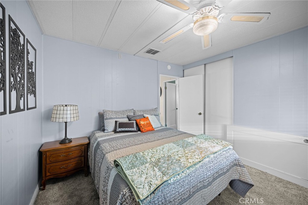 9800 Base Line Road, Unit 71 Rancho Cucamonga, CA 91701 - Photo 25 of 42 a bedroom with bed and a chandelier