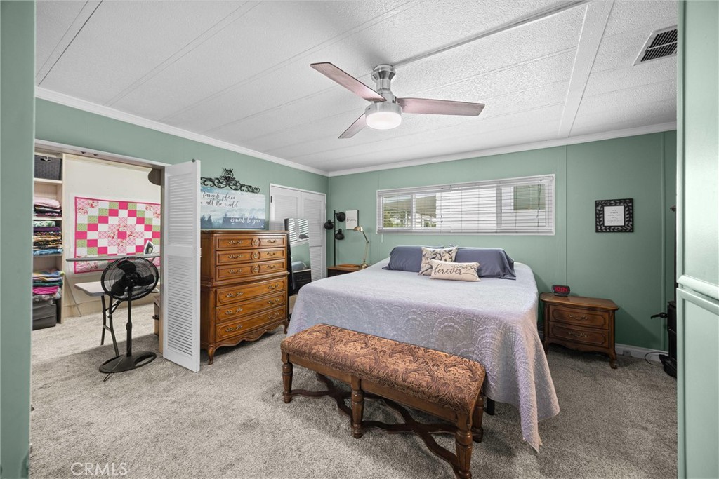 9800 Base Line Road, Unit 71 Rancho Cucamonga, CA 91701 - Photo 26 of 42 a bedroom with a bed and a flat tv screen