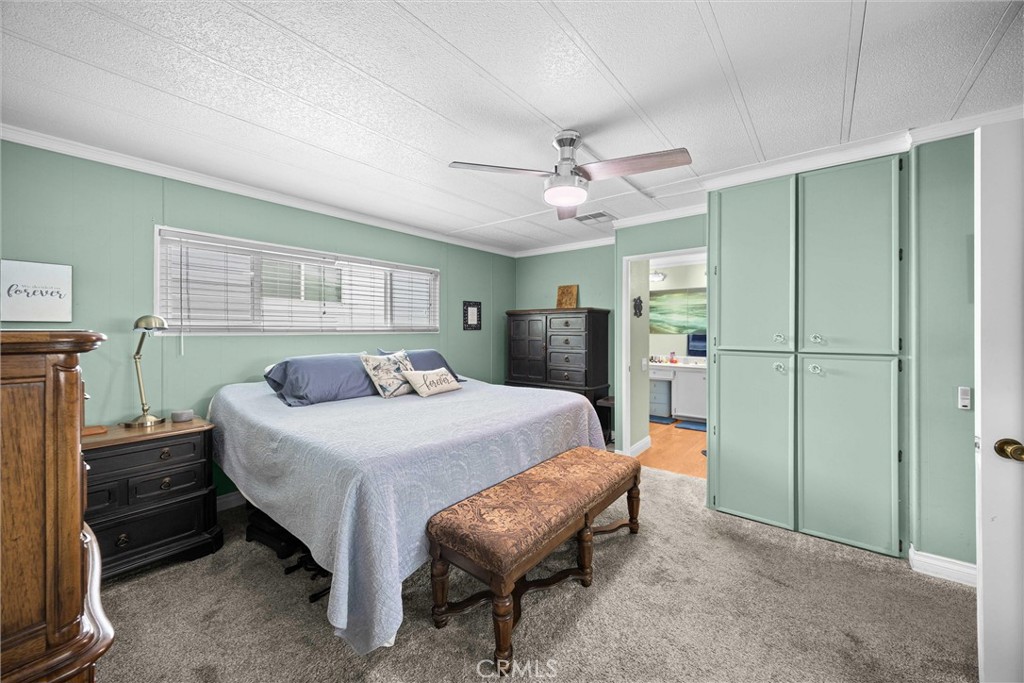 9800 Base Line Road, Unit 71 Rancho Cucamonga, CA 91701 - Photo 28 of 42 a spacious bedroom with a bed and a table