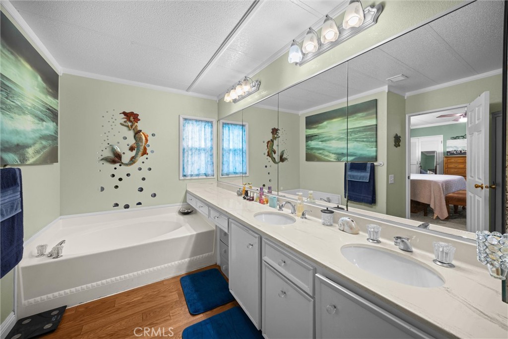 9800 Base Line Road, Unit 71 Rancho Cucamonga, CA 91701 - Photo 29 of 42 a bathroom with a tub double sink window and a mirror