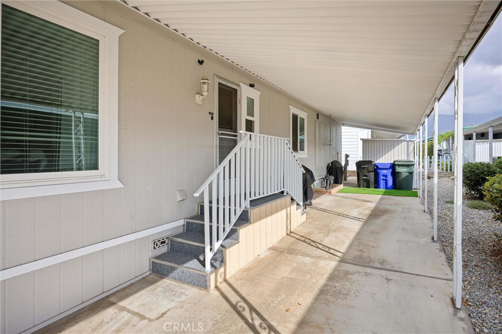 9800 Base Line Road, Unit 71 Rancho Cucamonga, CA 91701 - Photo 33 of 42 a view of a house with a small yard and a large window