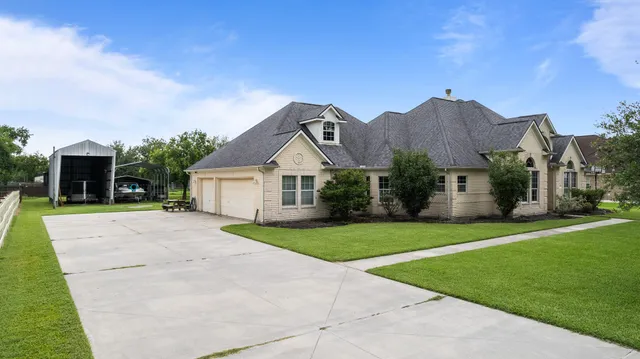 a front view of house with yard and green space