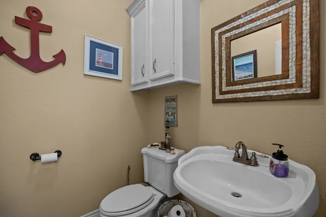 a bathroom with a sink mirror and toilet
