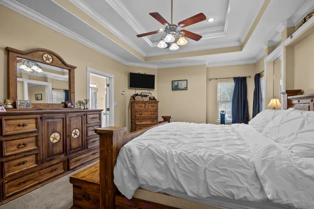 a bed room with a bed mirror and a desk