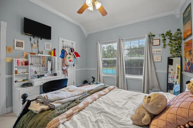 a bedroom with a bed and a flat screen tv