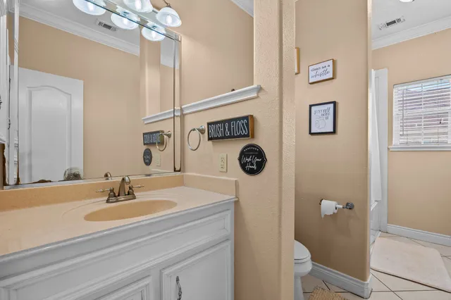 a bathroom with a sink a mirror a vanity and toilet