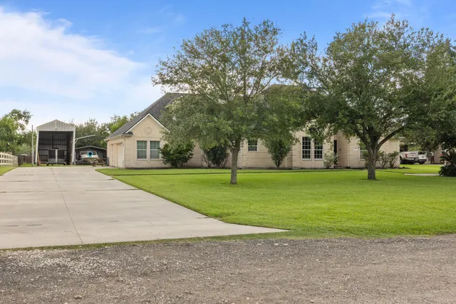 a front view of house with yard and green space