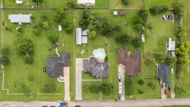an aerial view of residential houses with outdoor space and street view