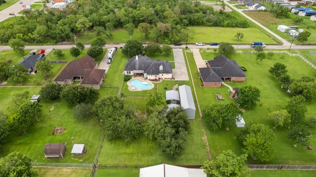 an aerial view of a house with a garden and lake view