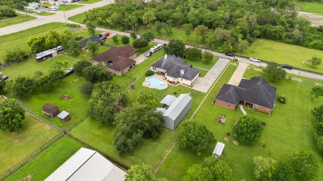 an aerial view of a house with a yard and lake view