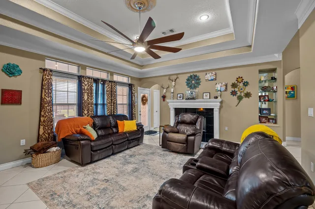a living room with furniture ceiling fan and a rug