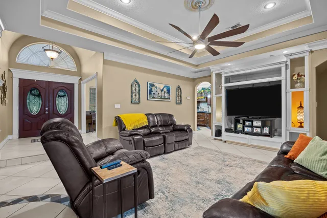 a living room with furniture a large window and a flat screen tv