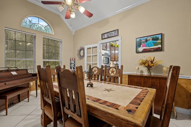 a view of a dining room with furniture and a chandelier