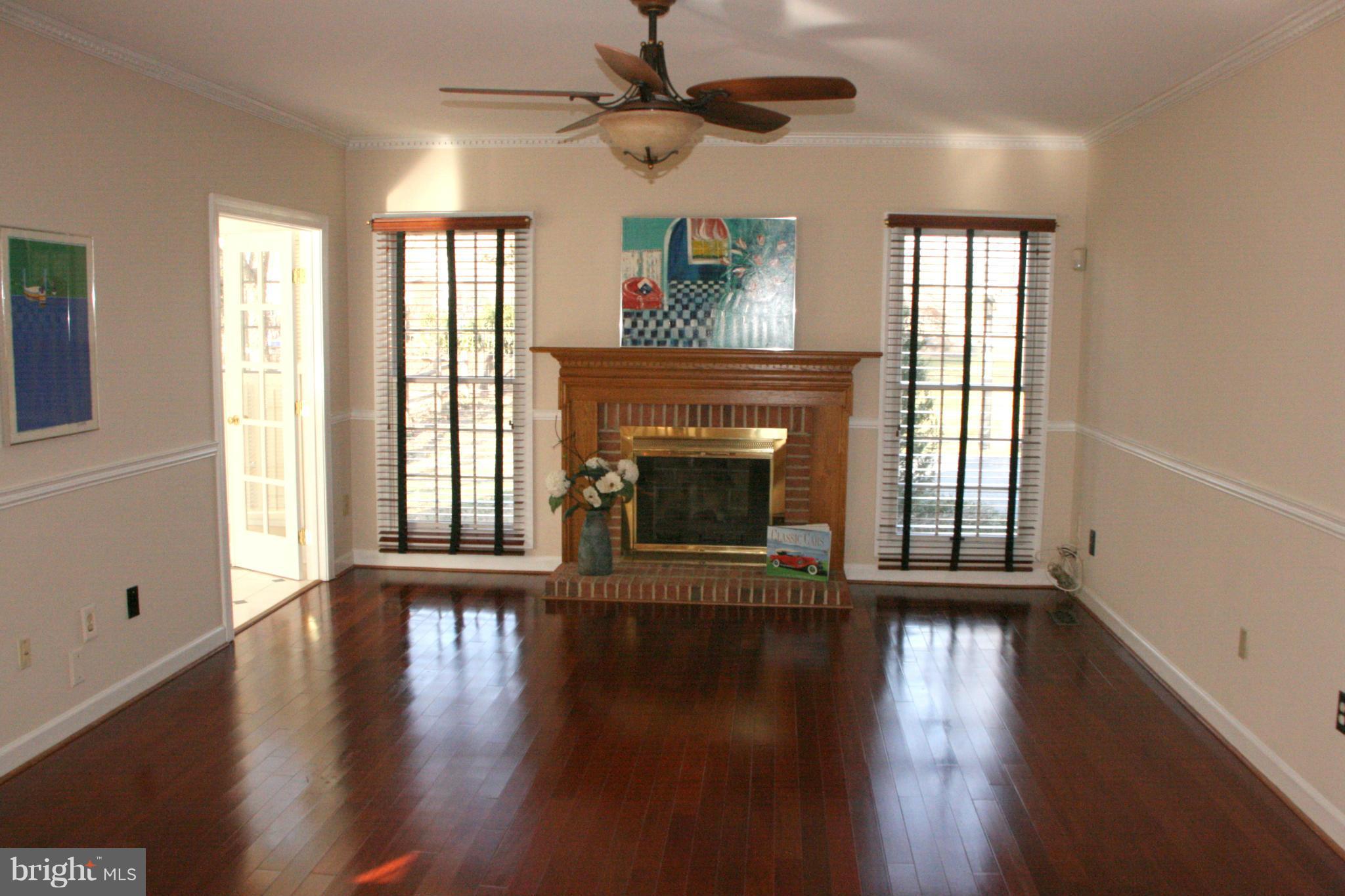 19810 Falling Spring Court Gaithersburg, MD 20882 - Photo 12 of 30 Family Room w/Brick FP opens to Kitchen & Sun Room