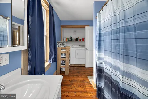 a bathroom with a tub and a view of bathroom