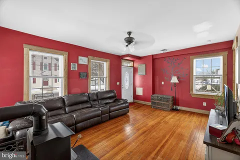 a living room with furniture a wooden floor and a window