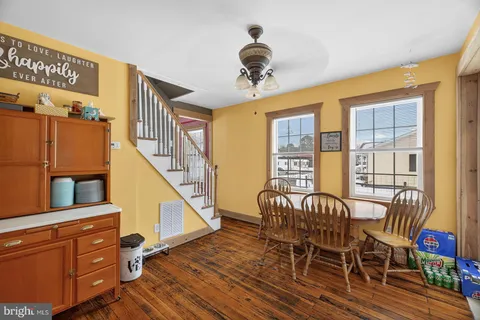 a view of a dining room with furniture wooden floor and chandelier