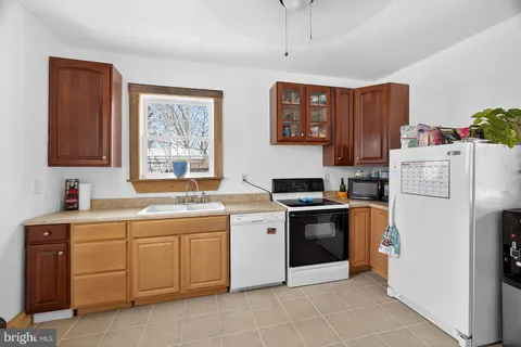a kitchen with a sink stove and refrigerator