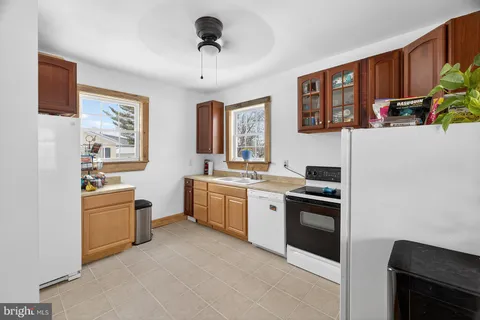 a kitchen with a stove a sink and a refrigerator