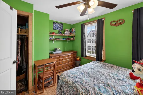 a bed room with a bed mirror and a window