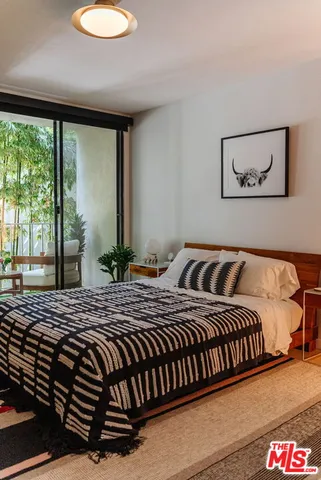 a bedroom with a bed and a large window