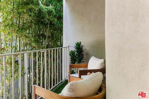 a view of a chair and tables in the back yard