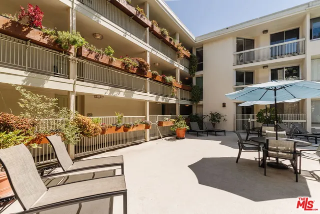 a view of a patio with a table and chairs
