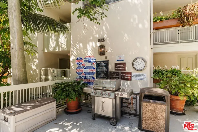 a front view of a house with garden and seating area