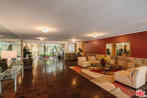 a living room with furniture and a table with wooden floor