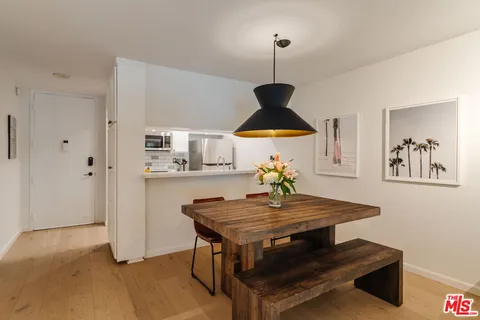 a view of kitchen island sink refrigerator and microwave