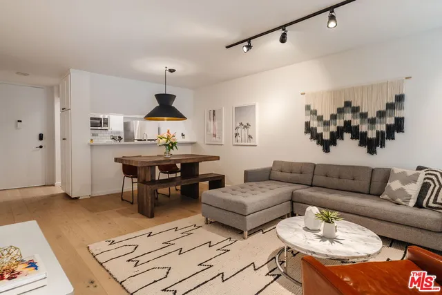 a living room with furniture a rug and a chandelier