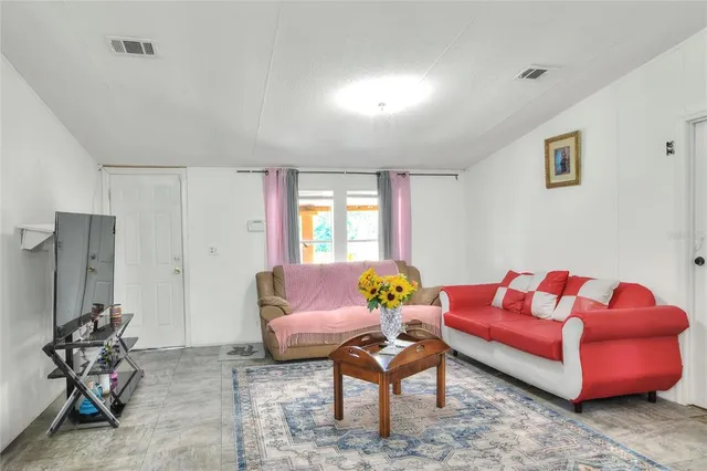 a living room with furniture and flowers