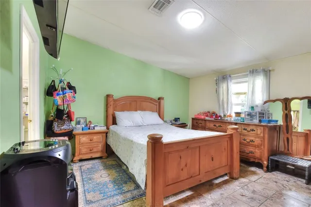 a bedroom with a bed and a dresser