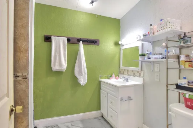 a bathroom with a sink vanity and a mirror