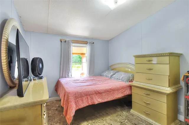 a bedroom with a bed and cabinets