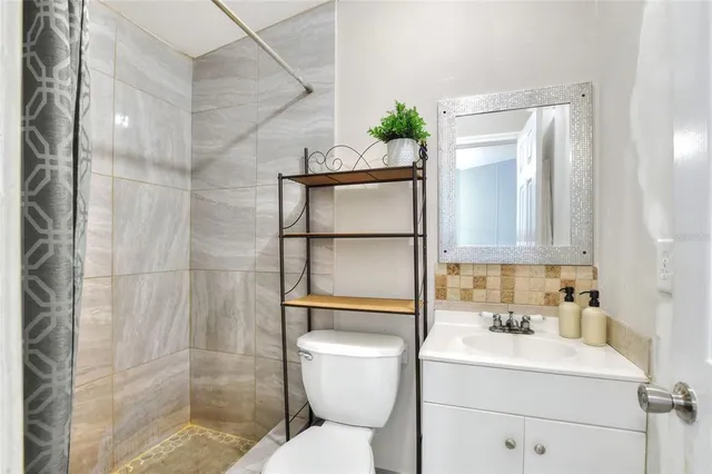 a bathroom with a sink toilet and shower