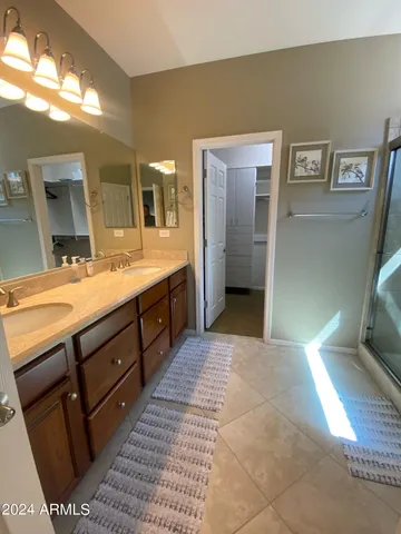 a spacious bathroom with a double vanity sink and a mirror