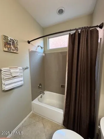 a bathroom with a shower curtain and a sink