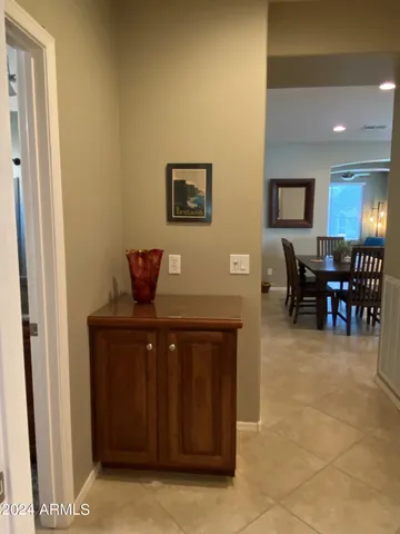 a living room with furniture a dining table and paintings on the wall